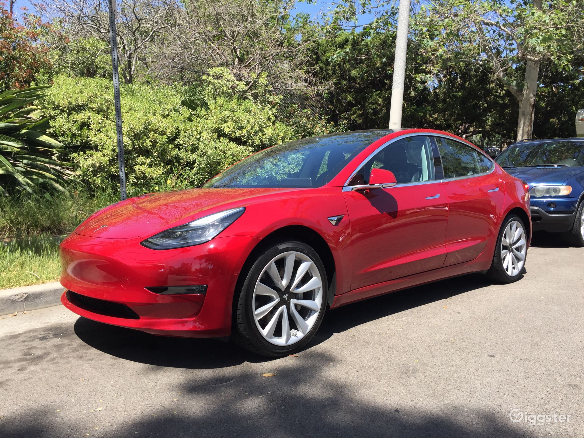 Tesla Model 3 in red Rent this location on Giggster