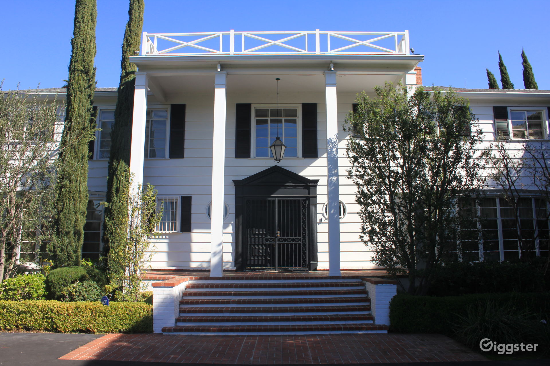 Colonial Mansion with Hedges & Pillars Rent this location on
