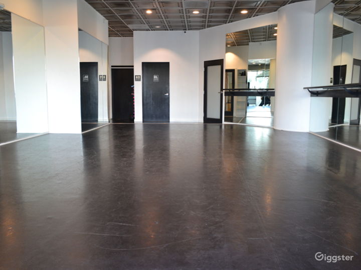 Dance studio with view of private bath door, office door, and back door.