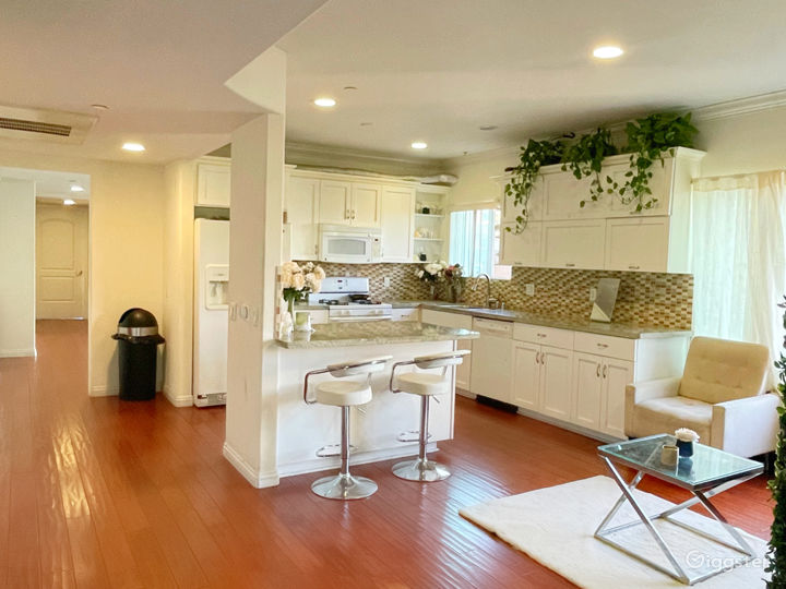 kitchen with white trim and dark brown wooden floors.