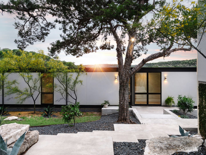 The front entrance has several steps and platforms meandering down to the front door.