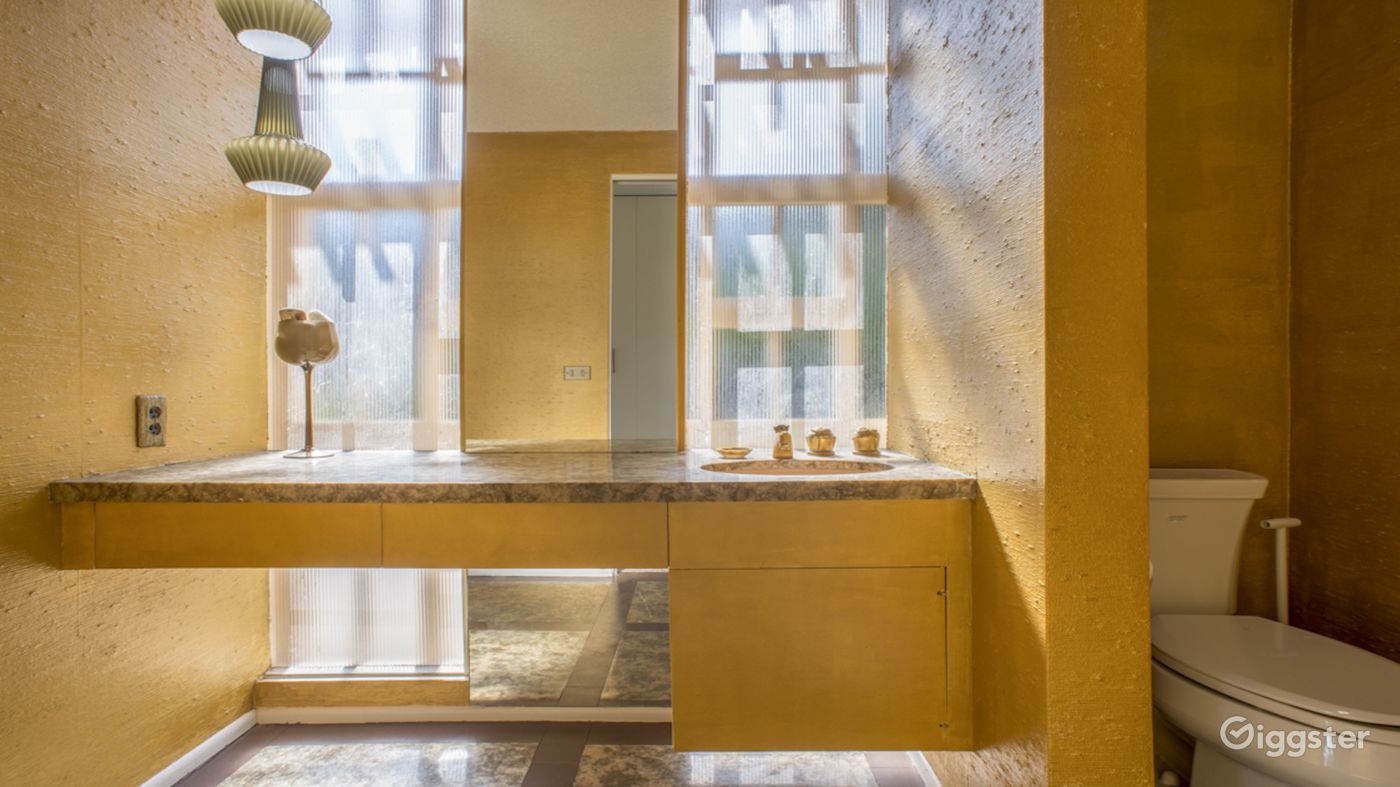 Gold splashed Powder Room with original 60' details