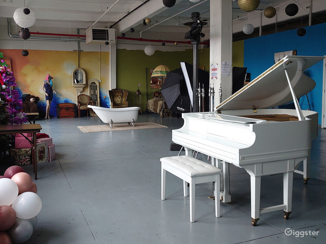  Huge space with white baby grand piano, bath tub, lots of furniture props 